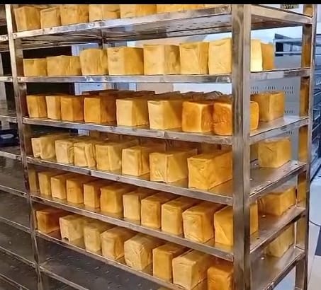 Freshly baked loaves cooling on bakery racks at Corecost